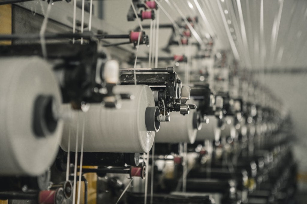 Conductive silver thread being woven into a Tala grounding sheet in production