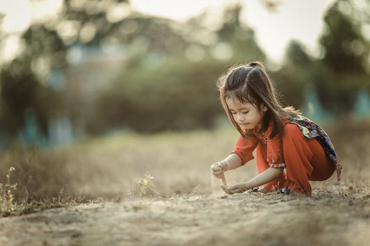 Child playing barefoot outdoors, illustrating grounding for kids